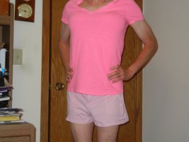 Dressed in pink shorts & a pink t-shirt. Underneath, I'm wearing a Victoria...