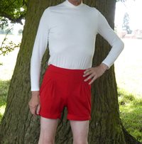 feminine red shorts and feminine white top in the park.