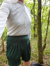 white blouse and green shorts in the woods