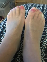 Pink toenails under white stockings