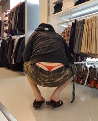 Shopping with red thong showing