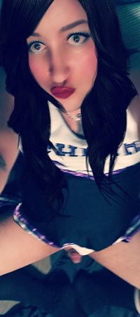 In a cheerleader outfit.