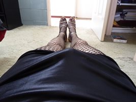 Fishnet stockings, leopard skin panties, high heels and leather skirt