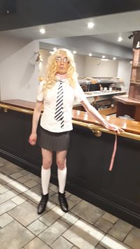 naughty school girl standing at a bar