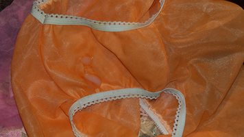 Orange nylon 1960s knickers during a spunking session.