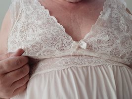Teasing my nipple through the lace of the gown.  My breasts want constant a...