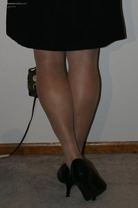 Black skirt, nude hose and heels.