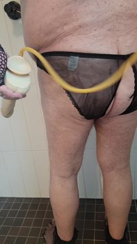 Enema in the shower using an 8 inch dildo as the nozzle.