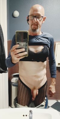 Faggot Andrew Brown in black bra and fishnet tights