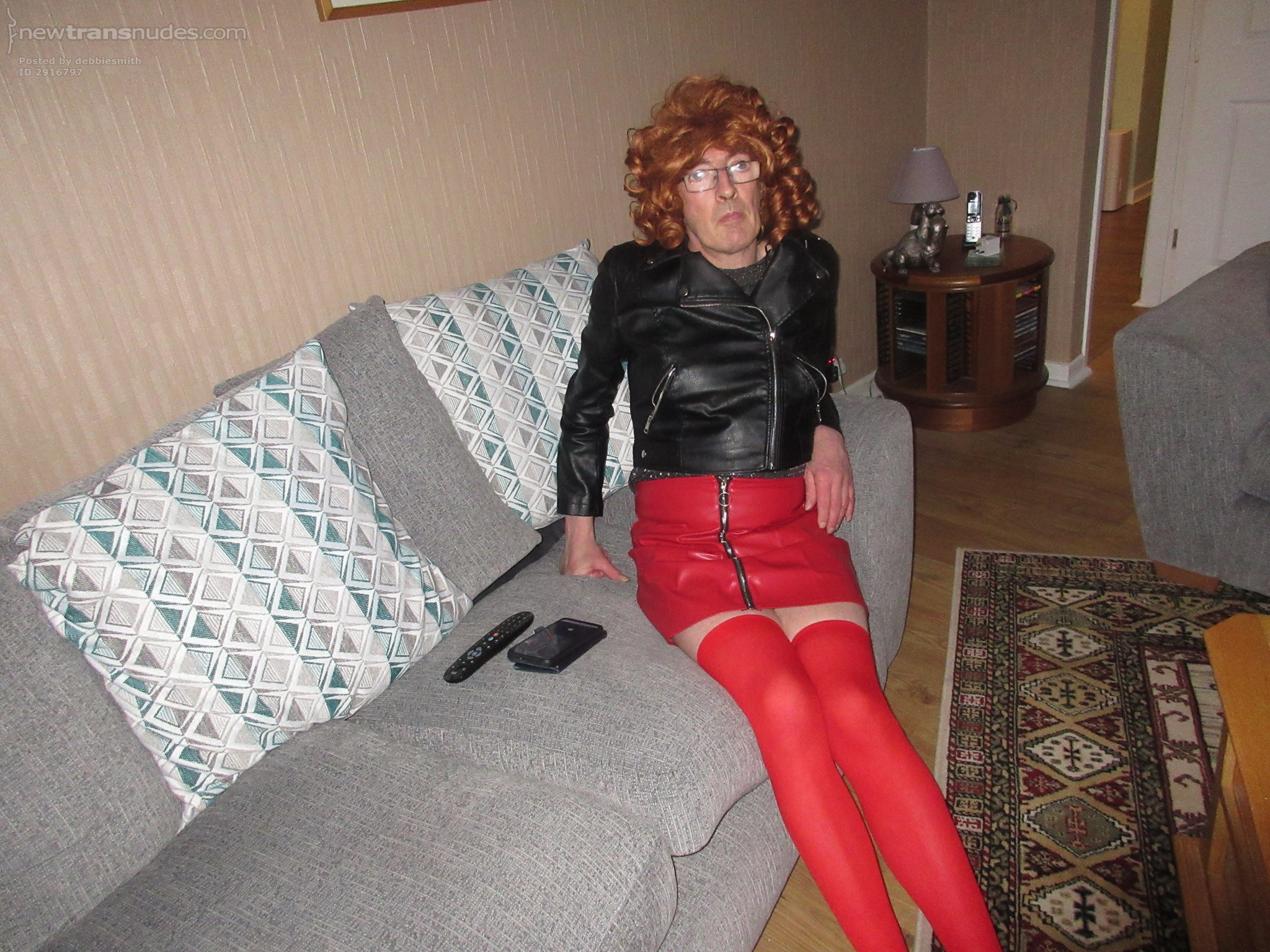 Debbie the slut posing in her new red leather skirt