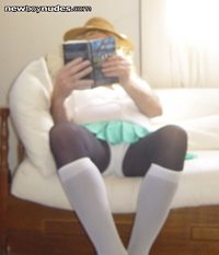 Schoolgirl reading book on decorum ?