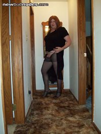 Black dress black pantyhose strappy heels showing off