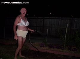 hoseing the garden in the front yard in my bra and panties