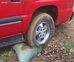 Using an old pillow to get the car out of the mud