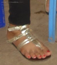 my wife in gold thongs. love sucking her toes while she is wearing her thon...